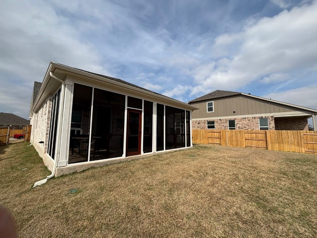 The same patio screened the full length, with a cedar door in the middle