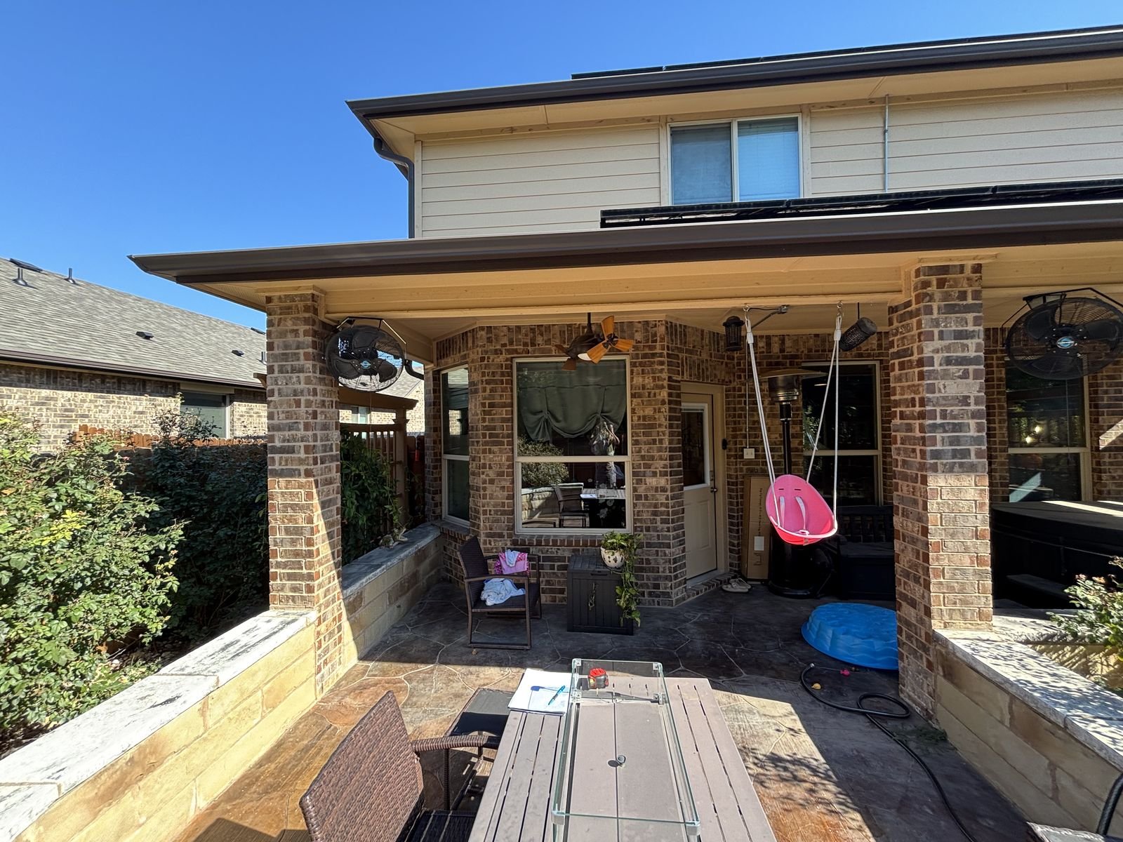 A covered brick patio before the porch catio conversion