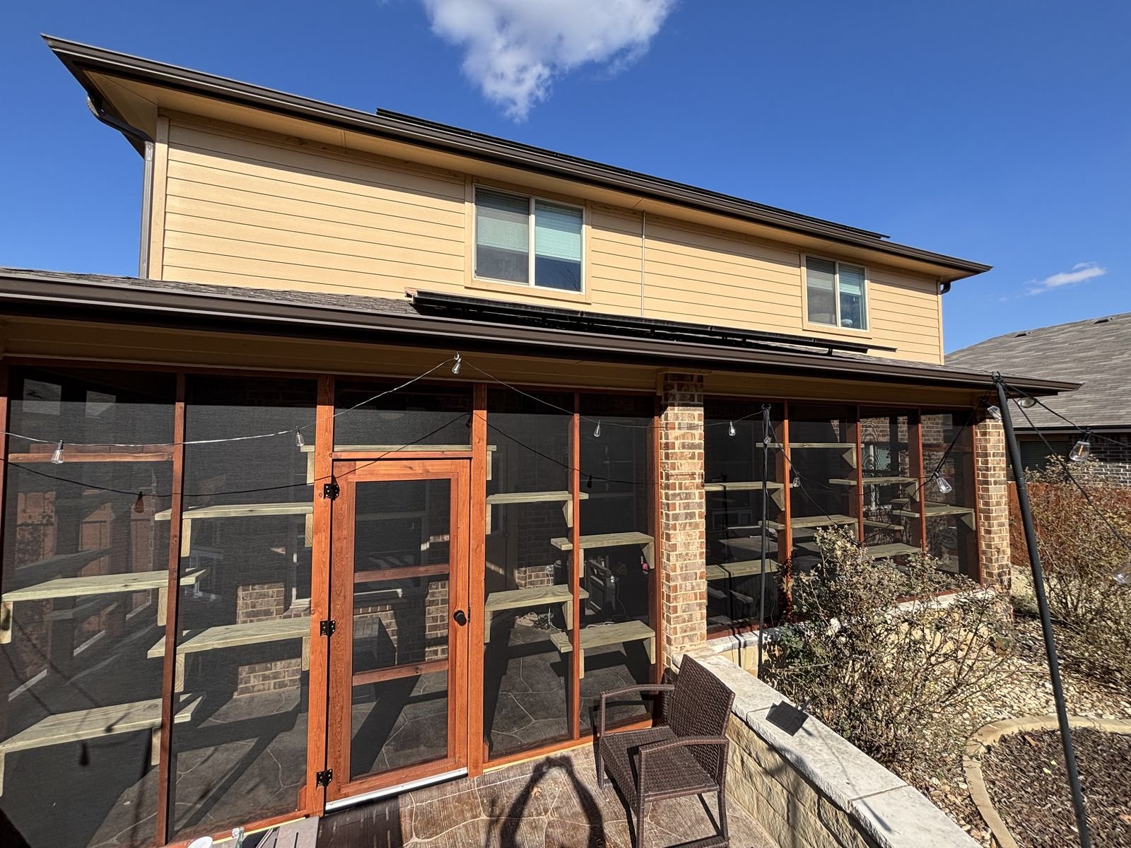 The same porch screened in cedar with shelving inside